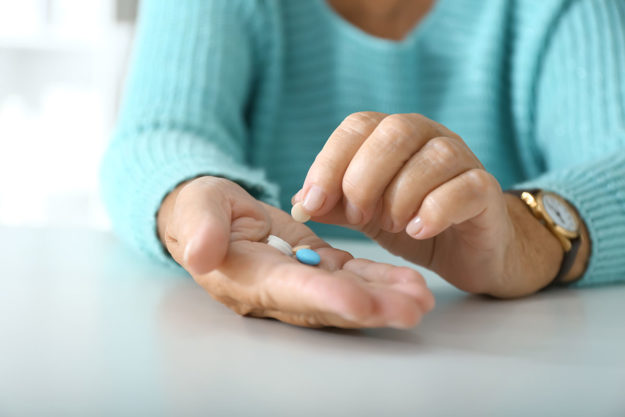 medication assisted treatment for opioid addiction (2) woman holding pills part of medication assisted treatment for opioid addiction