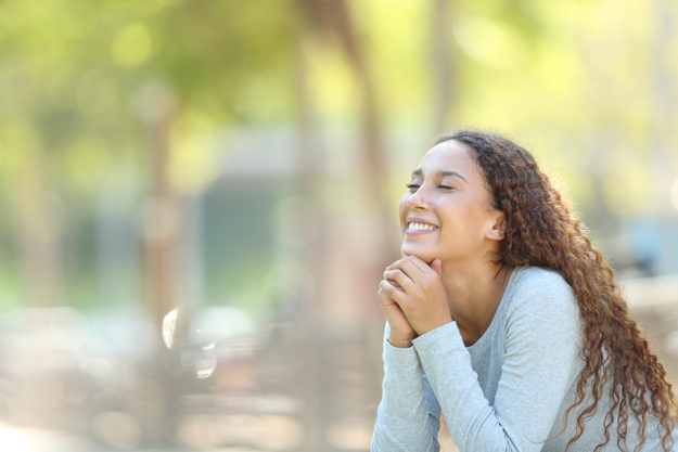 woman outdoors smiling knowing what is outpatient detox